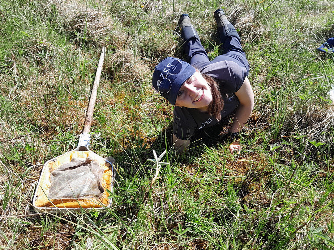Laura up to her armpit gathering a sample of mud. CREDIT: Clive Walton